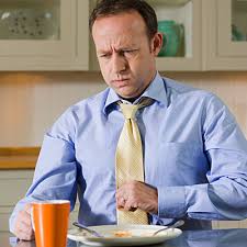 Man with heartburn holding stomach painfully