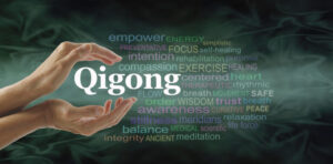 Hands practicing Qigong with floating words.