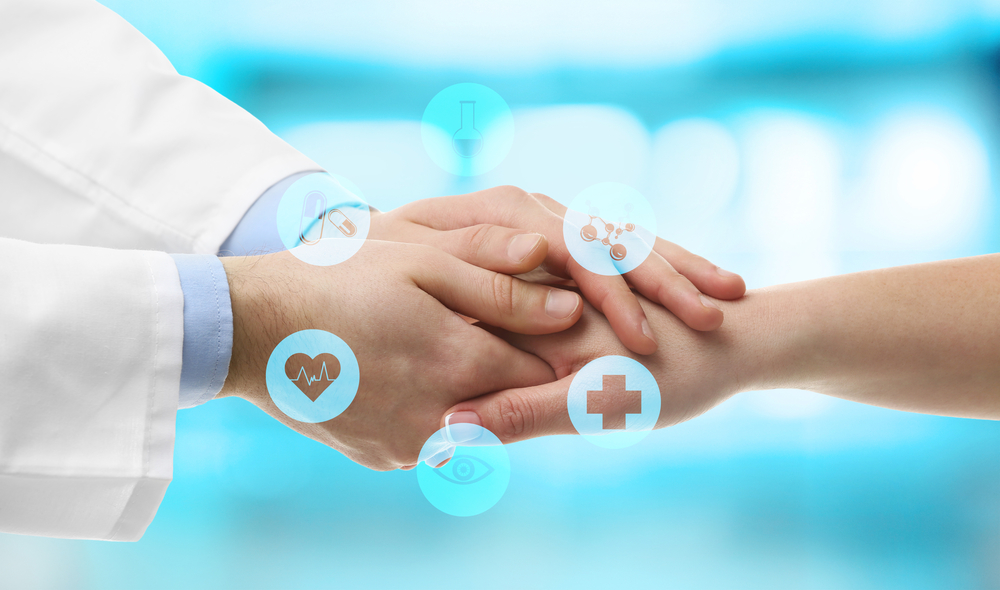 Physician and patient holding hands. 
