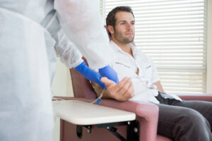 Men getting IV therapy by doctor.