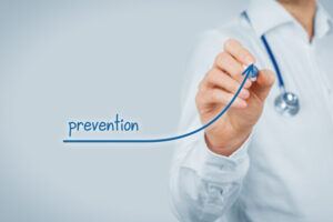 A doctor writing "prevention" on a board.