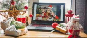 Woman on laptop with Xmas outfit.
