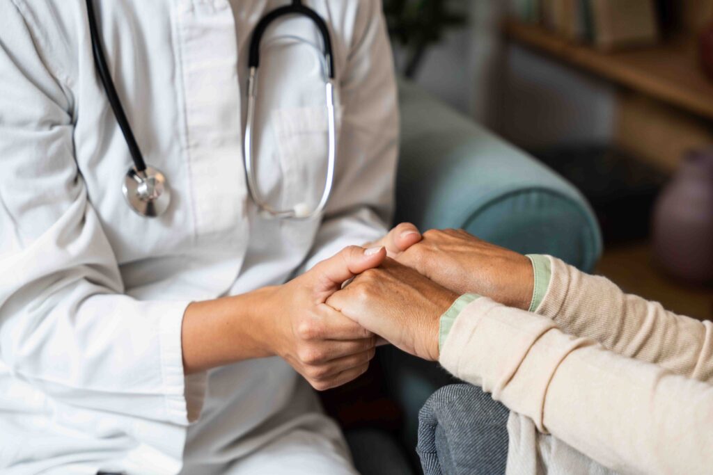 Doctor holding patient's hands.