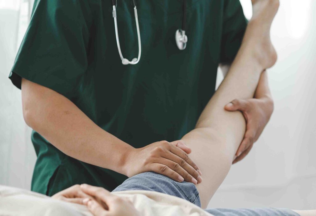 Doctor examining a patient's leg.