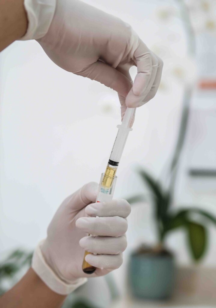 Doctor holding vile of PRP from blood.