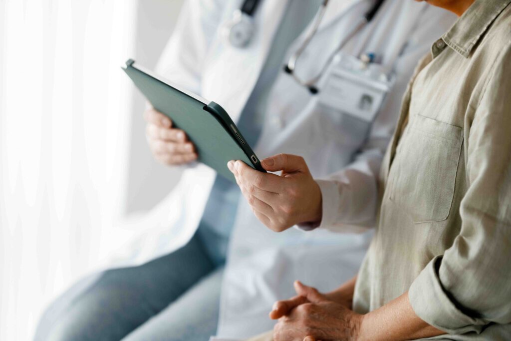 Doctor looking at ipad with patient.