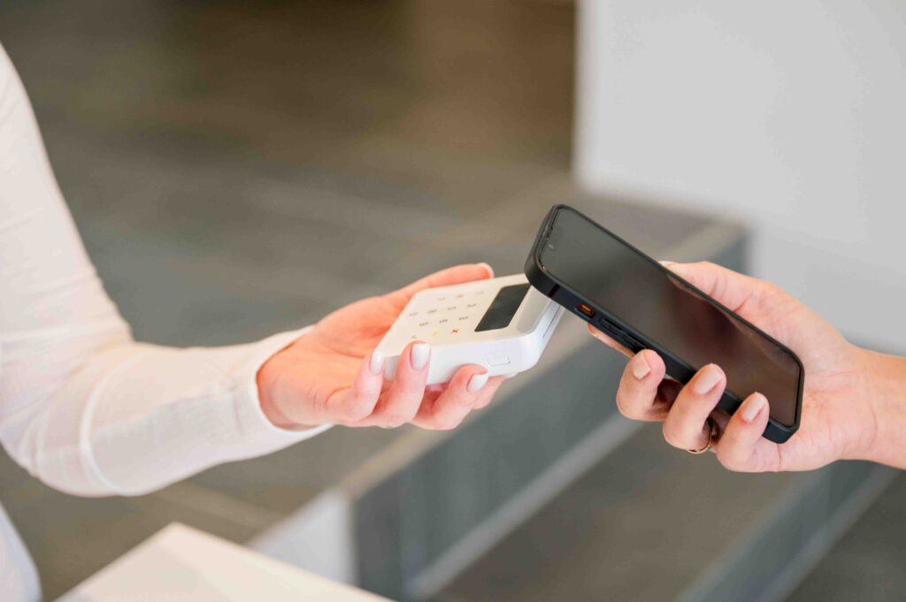 A patient paying for services with their phone.