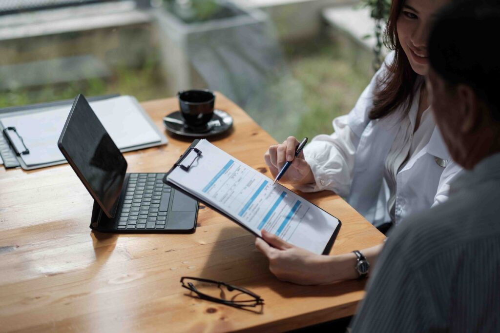 Doctor showing patient medical form on a tablet.