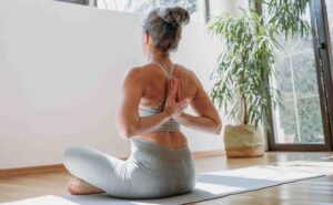Woman practicing yoga on mat.