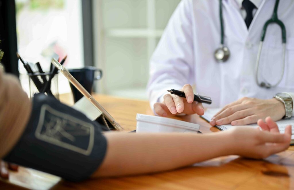 A doctor taking a patient's blood pressure.