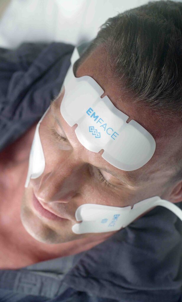 Man getting EMface sculpting.