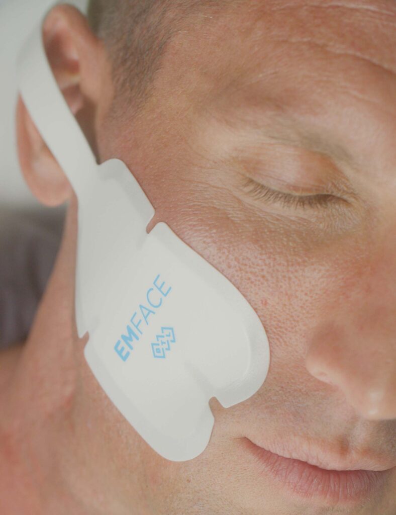 Man getting EMFACE face sculpting treatment.