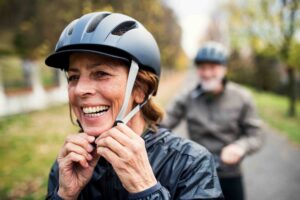 Middle aged woman and man exercising outdoors.