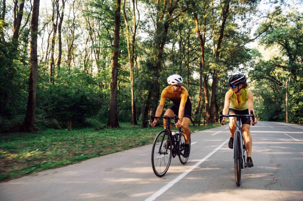 Man and woman cycling in the woods.